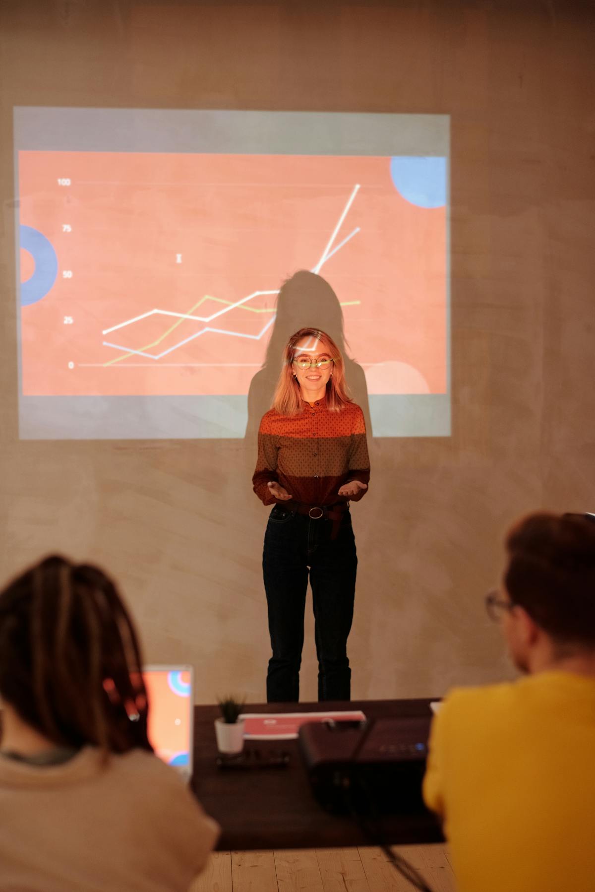 Professional presenting in front of projector screen